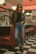 Female model wearing women's vintage distressed denim jeans